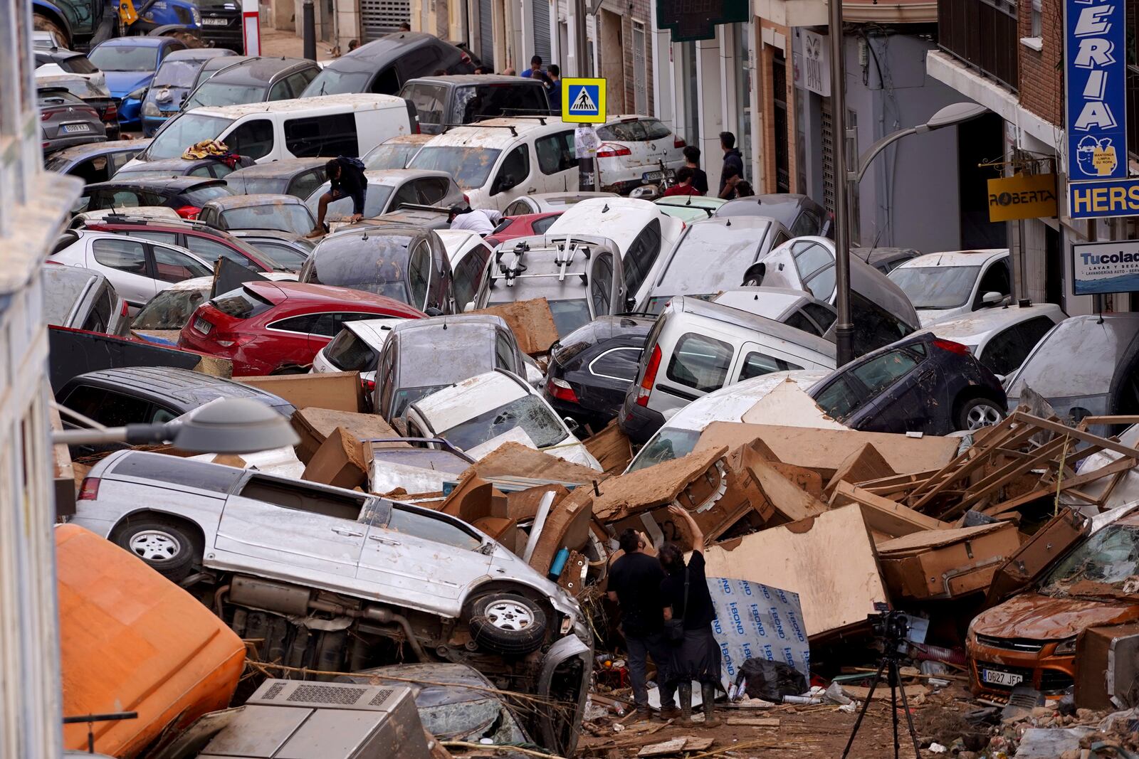 Vehicles are seen piled up after being swept away by floods in Valencia, Spain, Thursday, Oct. 31, 2024. (AP Photo/Alberto Saiz)