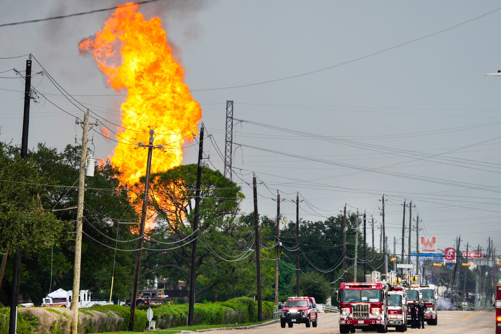 Emergency vehicles line Spencer Highway as firefighters respond to a massive burning pipeline fire near Spencer Highway and Summerton Monday, Sept. 16, 2024, in La Porte, Texas. (Brett Coomer/Houston Chronicle via AP)