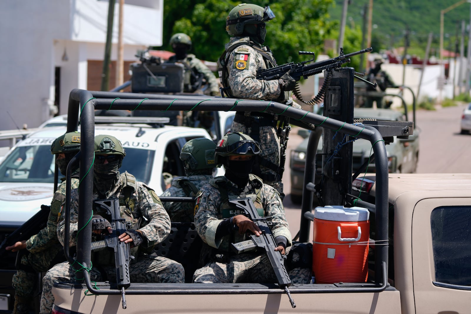 National Guard and Army forces patrol during an operation in a neighborhood of Culiacan, Sinaloa state, Mexico, Thursday, Sept. 19, 2024. (AP Photo/Eduardo Verdugo)