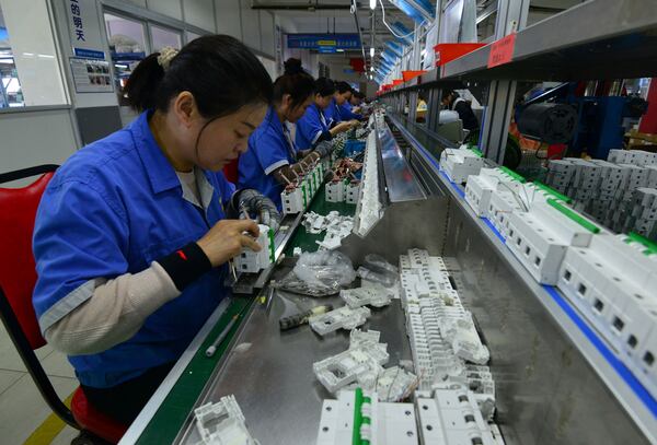 Workers assemble circuit breakers at a manufacturer of electronic equipment, in Fuyang city in central China's Anhui province on April 15, 2025. (Chinatopix via AP)