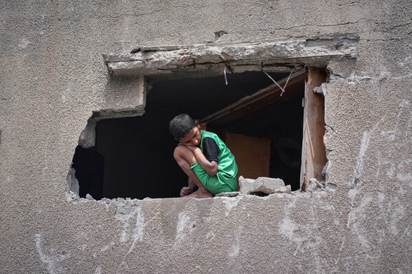 A boy looks as Palestinians search the rubble of a house targeted by an Israeli army strike that killed at least five people in Khan Younis, in the southern Gaza Strip, on Thursday, May 1, 2025. (AP Photo/Abdel Kareem Hana)