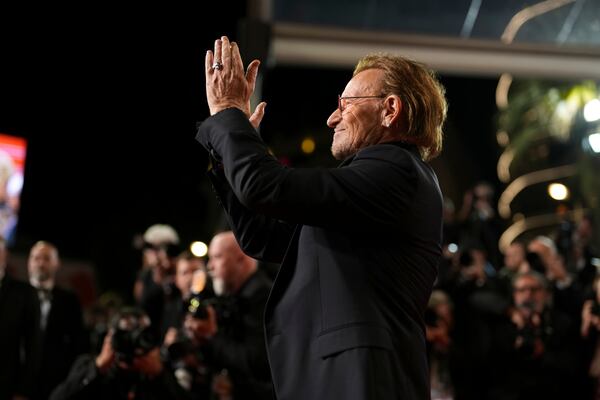 Bono poses for photographers upon arrival at the premiere of the film 'Bono: Stories of Surrender' at the 78th international film festival, Cannes, southern France, Friday, May 16, 2025. (AP Photo/Natacha Pisarenko)