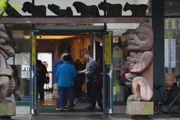 Voters line up at a polling location at the Collingwood Neighbourhood House in Vancouver, British Columbia, Monday, April 28, 2025. (AP Photo/Lindsey Wasson)