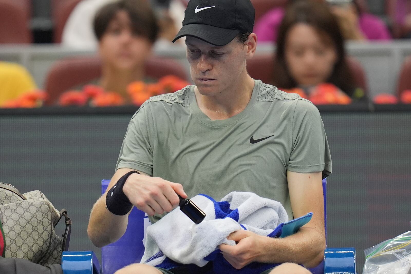 Italy's Jannick Sinner rests between sets against Roman Safiullin of Russia during the China Open tennis tournament held at the National Tennis Center in Beijing, Saturday, Sept. 28, 2024. (AP Photo/Ng Han Guan)