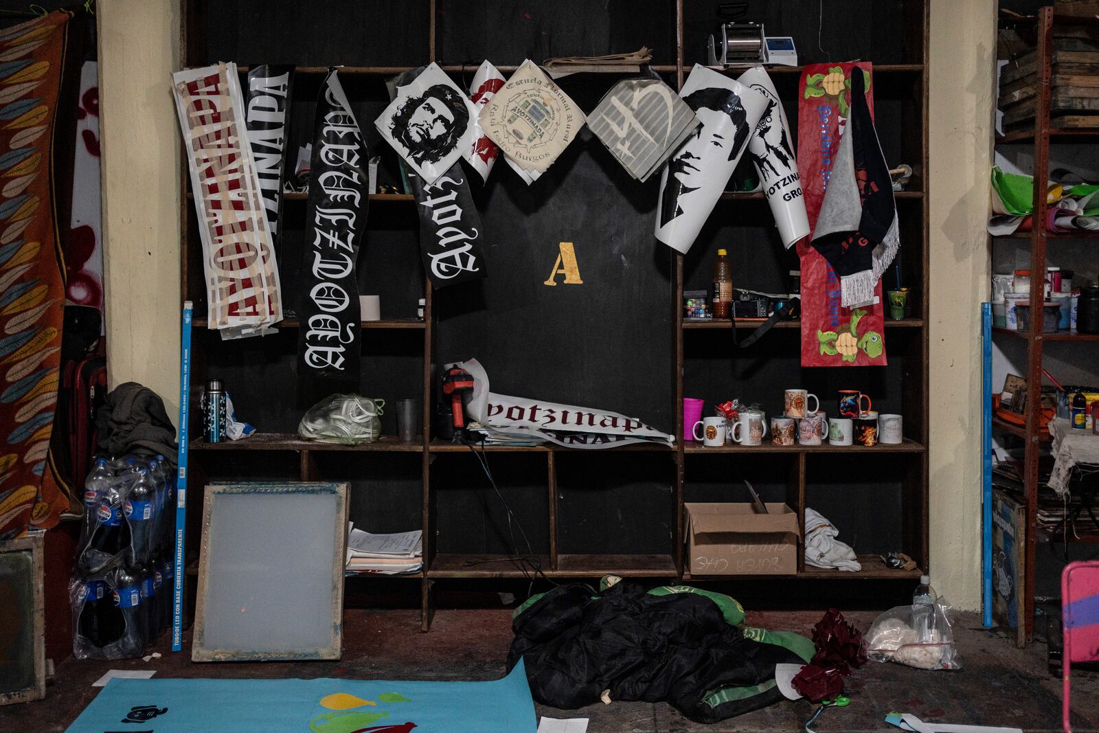 Political posters and stickers hang inside the print shop at the Raúl Isidro Burgos Rural Normal School in Ayotzinapa, Guerrero state, Mexico, Sunday, Aug. 25, 2024. (AP Photo/Felix Marquez)