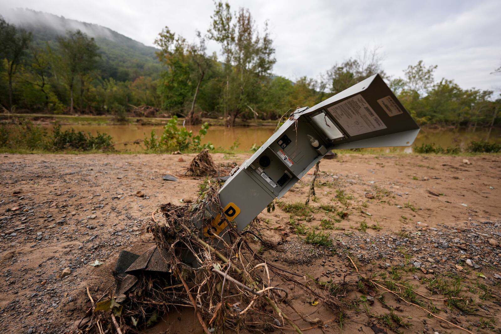 An electrical box is damaged after flash flooding in the aftermath of Hurricane Helene, Tuesday, Oct. 1, 2024, in Swannanoa, N.C. (AP Photo/Mike Stewart)