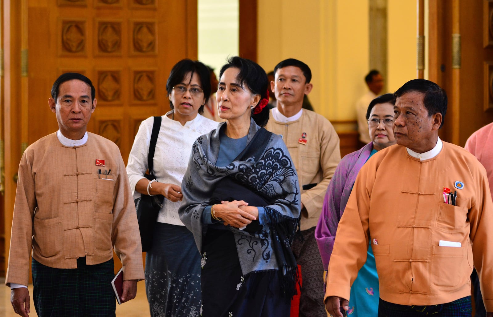 FILE - Zaw Myint Maung, right, an imprisoned politician and a close colleague of Myanmar’s ousted leader Aung San Suu Kyi, center, walks with her and Win Myint, left, who was then selected as speaker for the lower house, during a regular session of Parliament on Jan. 28, 2016, in Naypyitaw, Myanmar. (AP Photo/Aung Shine Oo, File)