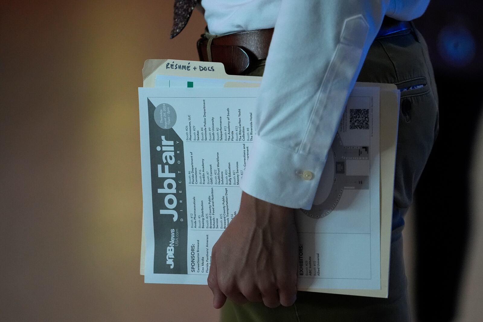 A person waits in a line for a prospective employer at a job fair, Thursday, Aug. 29, 2024, in Sunrise, Fla. (AP Photo/Lynne Sladky)