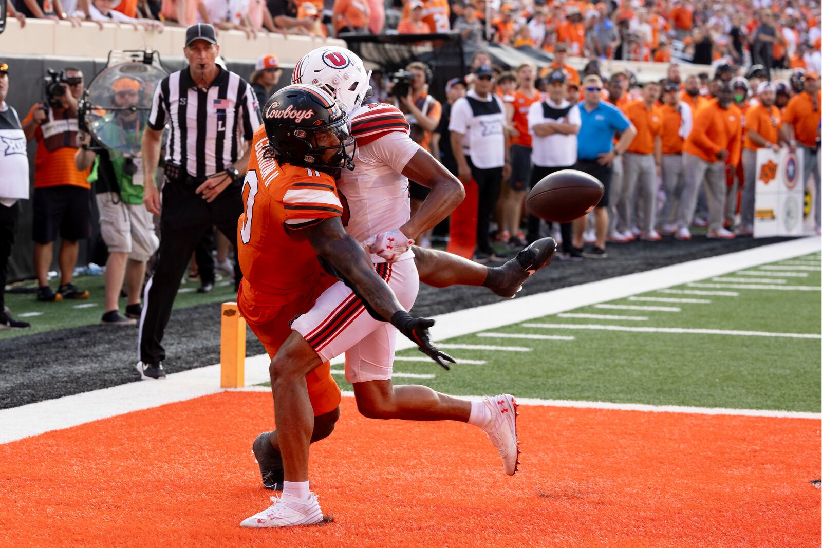 Utah safety Rabbit Evans (13) is called for defensive pass interference on Oklahoma State running back Ollie Gordon II (0) during a two-point conversion attempt in the second half of an NCAA college football game Saturday, Sept. 21, 2024, in Stillwater, Okla. (AP Photo/Mitch Alcala)