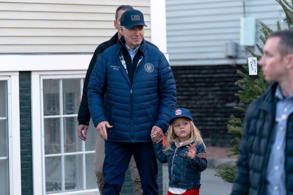 President Joe Biden holds the hand of his grandson Beau as they walk in downtown Nantucket, Mass., Friday, Nov. 29, 2024. (AP Photo/Jose Luis Magana)