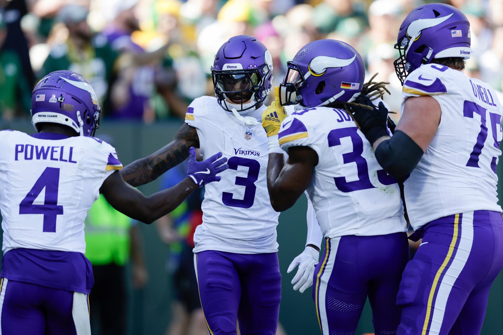 Minnesota Vikings wide receiver Jordan Addison (3) celebrates his touchdown with teammates, Brandon Powell (4), Aaron Jones (33) and Tyrese Robinson (79) during the first half of an NFL football game against the Green Bay Packers, Sunday, Sept. 29, 2024, in Green Bay, Wis. (AP Photo/Matt Ludtke)