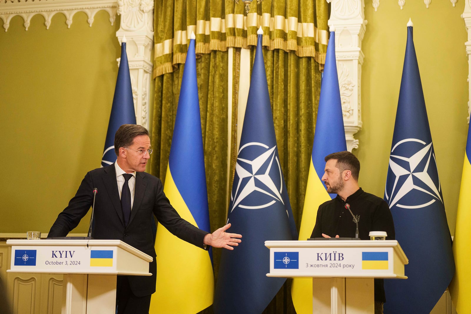 NATO Secretary General Mark Rutteleft, and Ukrainian President Volodymyr Zelenskyy, right, speak to journalists during press conference in Kyiv, Ukraine, Thursday, Oct. 3, 2024. (AP Photo/Evgeniy Maloletka)