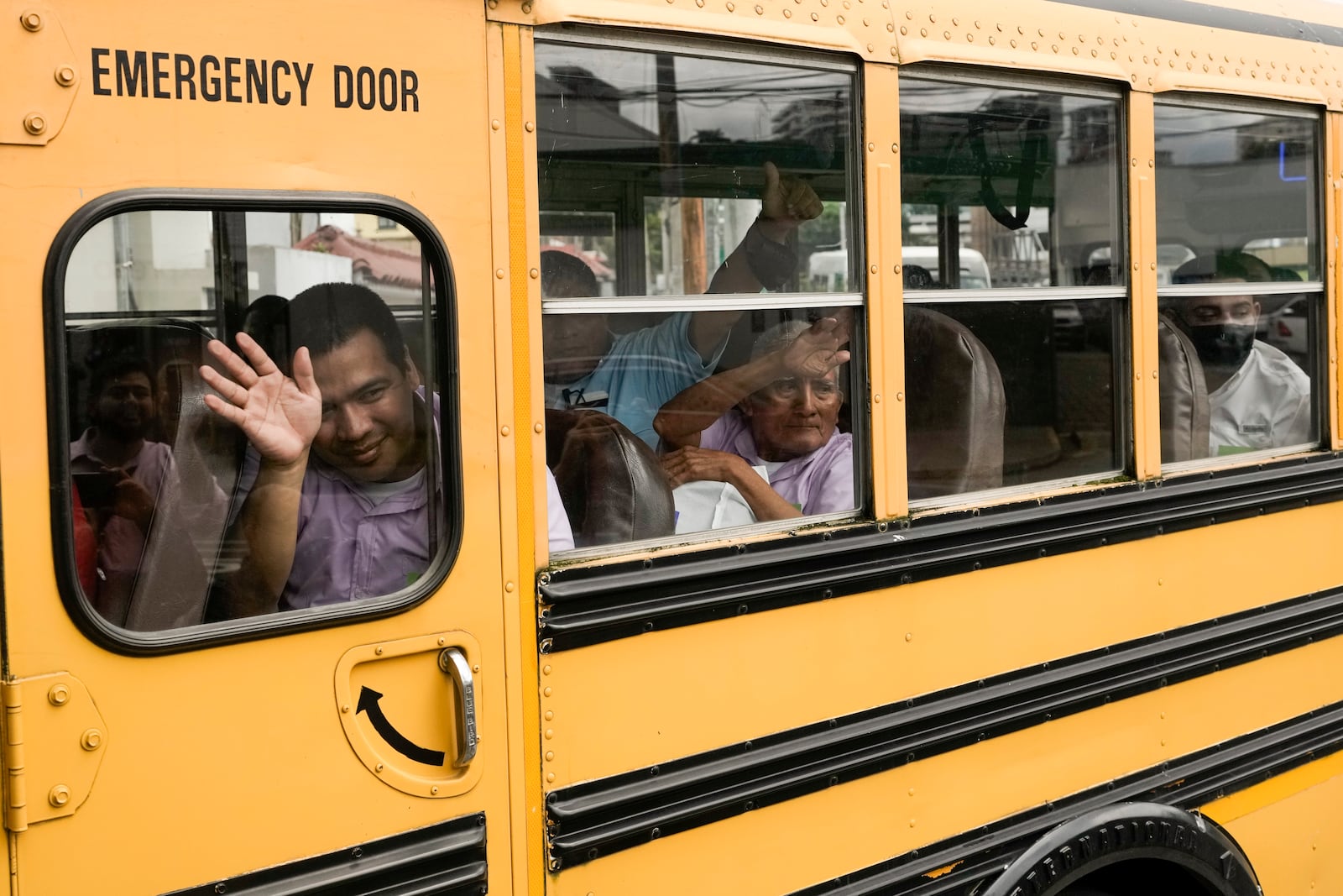 FILE - Nicaraguan citizens wave from a bus after being released from a Nicaraguan jail and landing at the airport in Guatemala City, Sept. 5, 2024. (AP Photo/Moises Castillo, File)