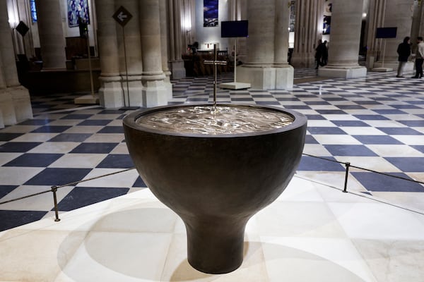 The baptistery designed by French artist and designer Guillaume Bardet is seen at Notre-Dame de Paris cathedral while French President Emmanuel Macron visits the restored interiors of the monument, Friday Nov. 29, 2024, in Paris. (Stephane de Sakutin, Pool via AP)