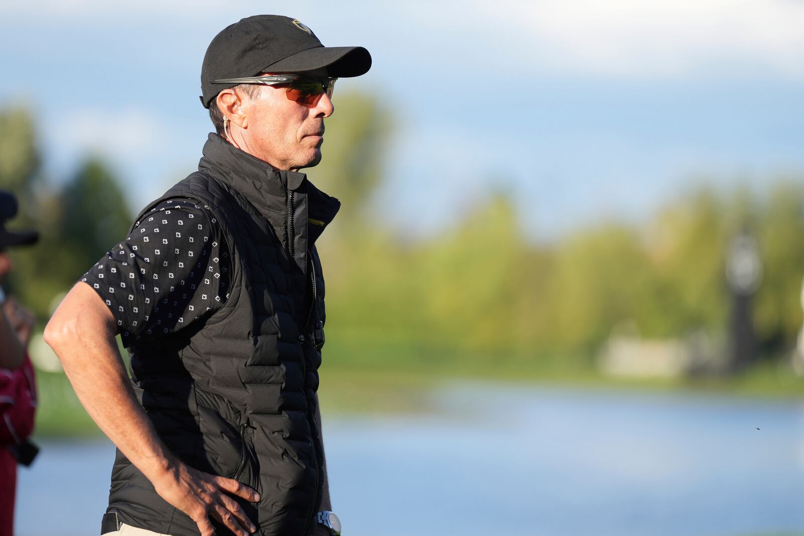 International team captain Mike Weir watches the action on the the 16th hole during a first round four-ball match at the Presidents Cup golf tournament at the Royal Montreal Golf Club in Montreal, Thursday, Sept. 26, 2024. (Christinne Muschi/The Canadian Press via AP)