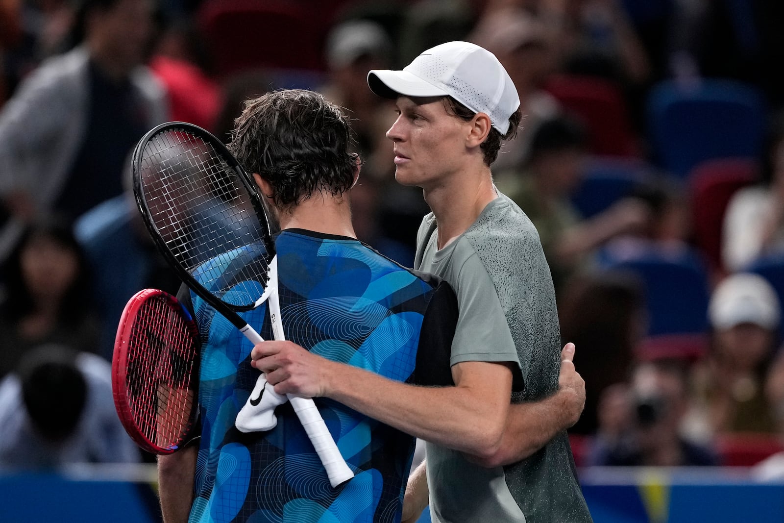 Jannik Sinner of Italy, right, hugs with Tomas Machac of the Czech Republic after winning in their men's singles semifinals match of the Shanghai Masters tennis tournament at Qizhong Forest Sports City Tennis Center in Shanghai, China, Saturday, Oct. 12, 2024. (AP Photo/Andy Wong)