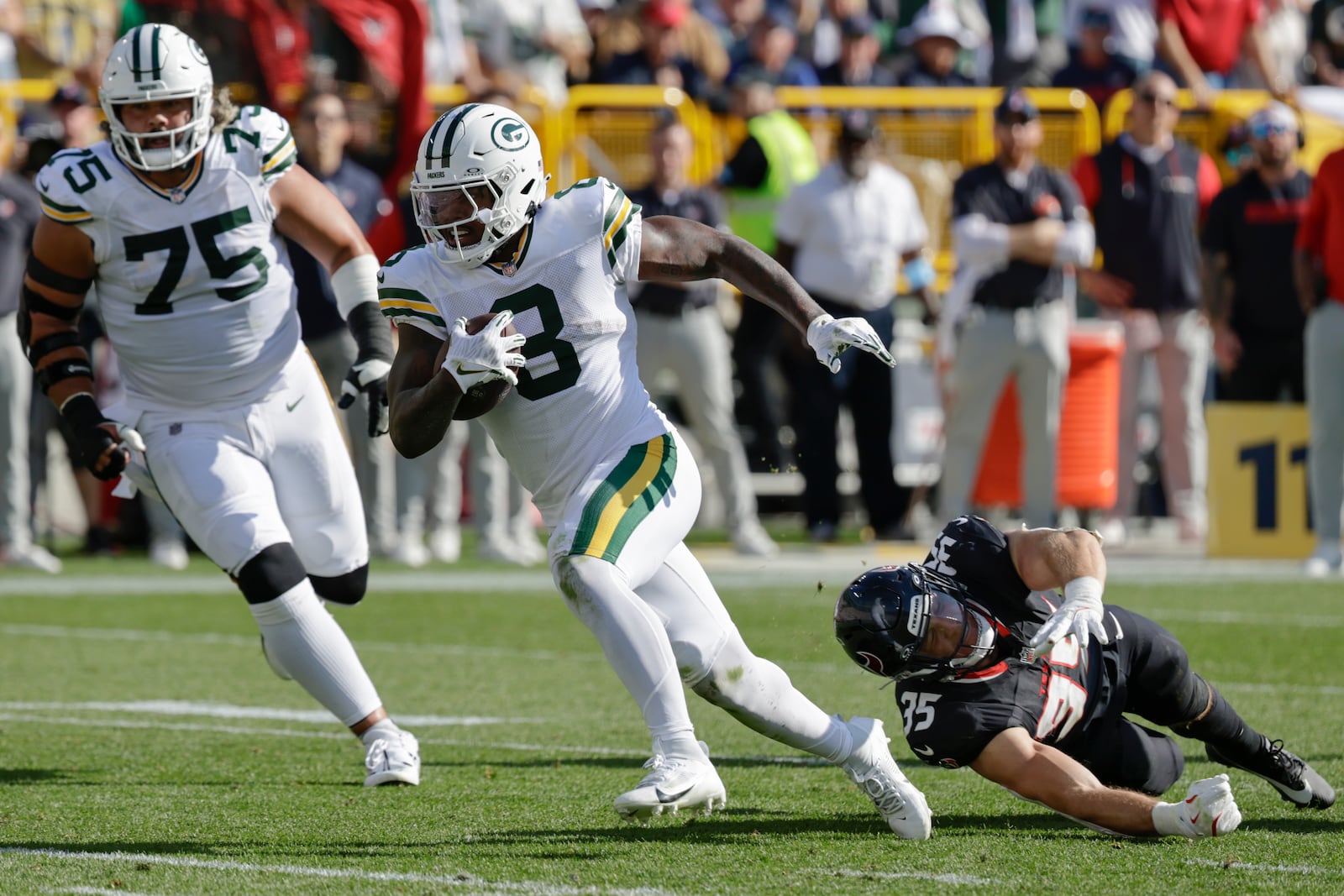 Green Bay Packers running back Josh Jacobs (8) runs for a touchdown during the second half of an NFL football game against the Houston Texans, Sunday, Oct. 20, 2024, in Green Bay, Wis. (AP Photo/Mike Roemer)