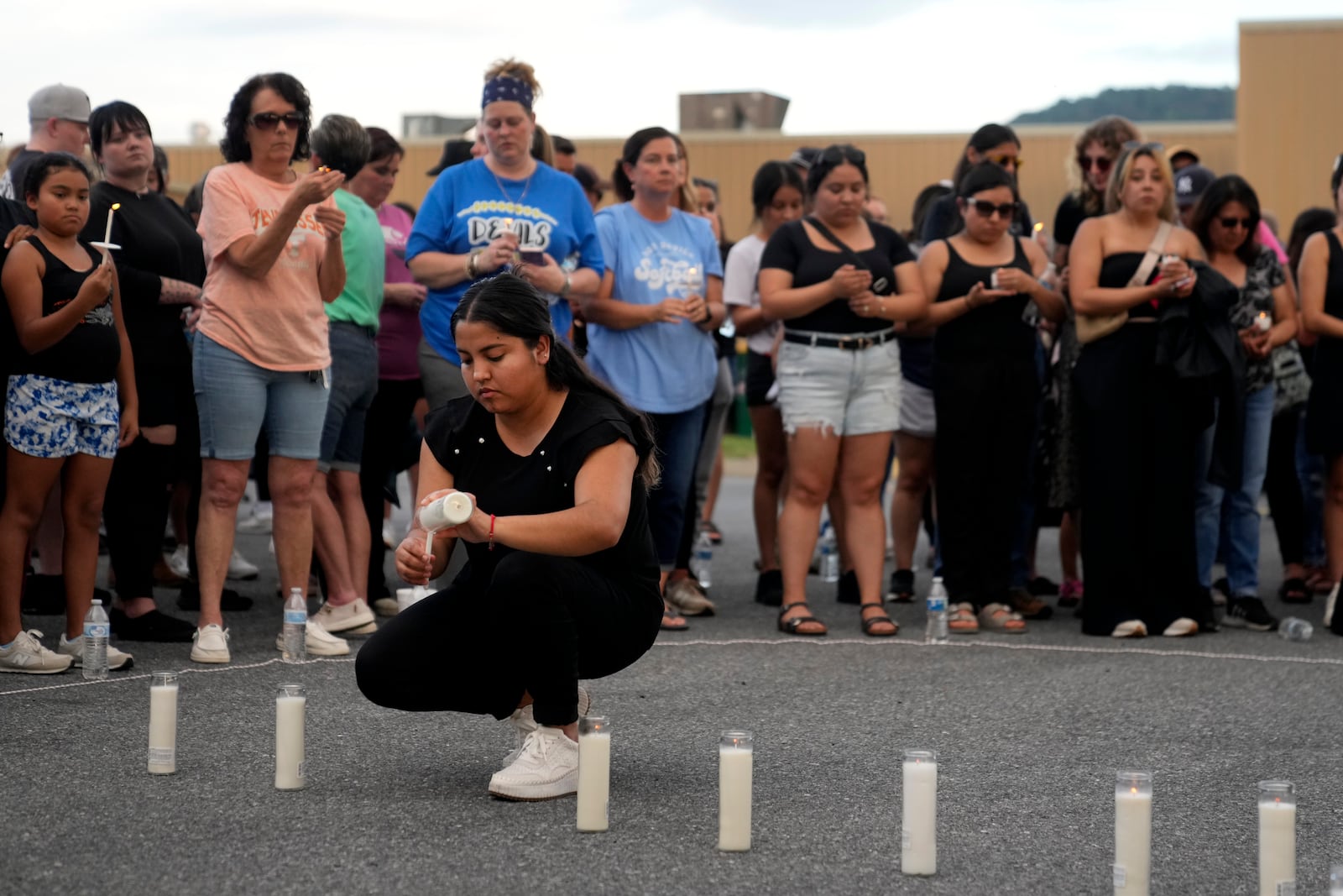 Tennessee Immigrant and Refugee Rights Coalition worker Ana Gutierrez, lights a candle during a vigil for victims of the Impact Plastics tragedy in the days after Hurricane Helene in Erwin, Tenn., on Thursday, Oct. 3, 2024. (AP Photo/Jeff Roberson)