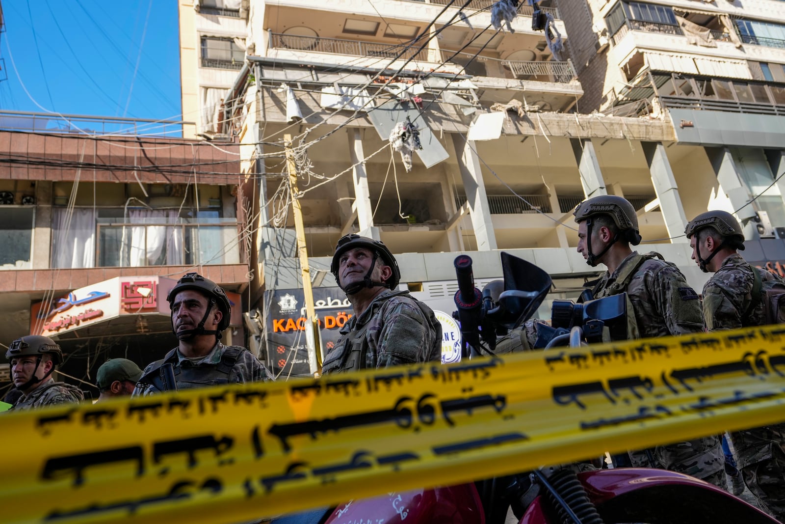 Lebanese soldiers cordon off the area at the site of an Israeli airstrike in Beirut's southern suburbs, Thursday, Sept. 26, 2024. (AP Photo/Hassan Ammar)