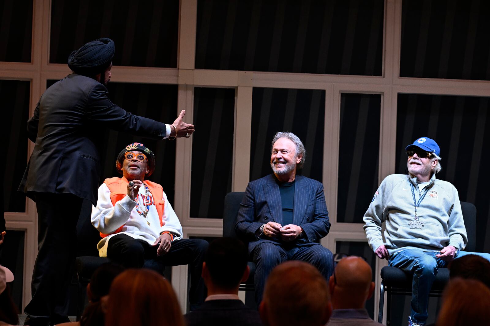 Toronto Raptors superfan Nav Bhatia, left, speaks to comedian Billy Crystal, second from right, as film director Spike Lee, second from left, and businessman Alan Horwitz, right, look on at a superfan ceremony at the Basketball Hall of Fame, Sunday, Oct. 13, 2024, in Springfield, Mass. Crystal, Lee, Horwitz and actor Jack Nicholson are being added to the Naismith Memorial Basketball Hall of Fame's James F. Goldstein SuperFan Gallery. (AP Photo/Jessica Hill)