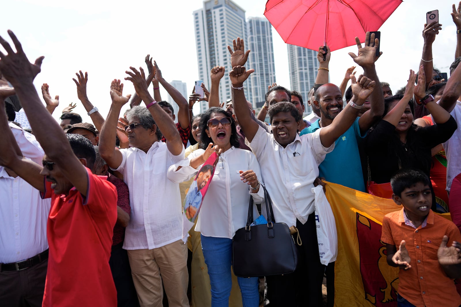 Supporters of Marxist lawmaker Anura Kumara Dissanayake cheer outside the president's office as he arrives to be sworn in as Sri Lanka’s tenth president in Colombo, Sri Lanka, Monday, Sept. 23, 2024. (AP Photo/Eranga Jayawardena)