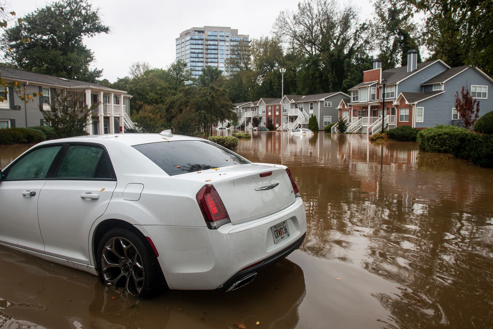 One of several stranded cars is seen at a flooded apartment complex after Hurricane Helene passed the area on Friday, Sept. 27, 2024, in Atlanta. (AP Photo/Ron Harris)