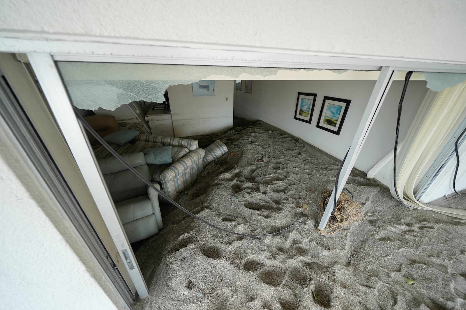 Several feet of sand fills a condo following the passage of Hurricane Milton, at YCA Vacation Rentals in Venice, Fla., Friday, Oct. 11, 2024. (AP Photo/Rebecca Blackwell)