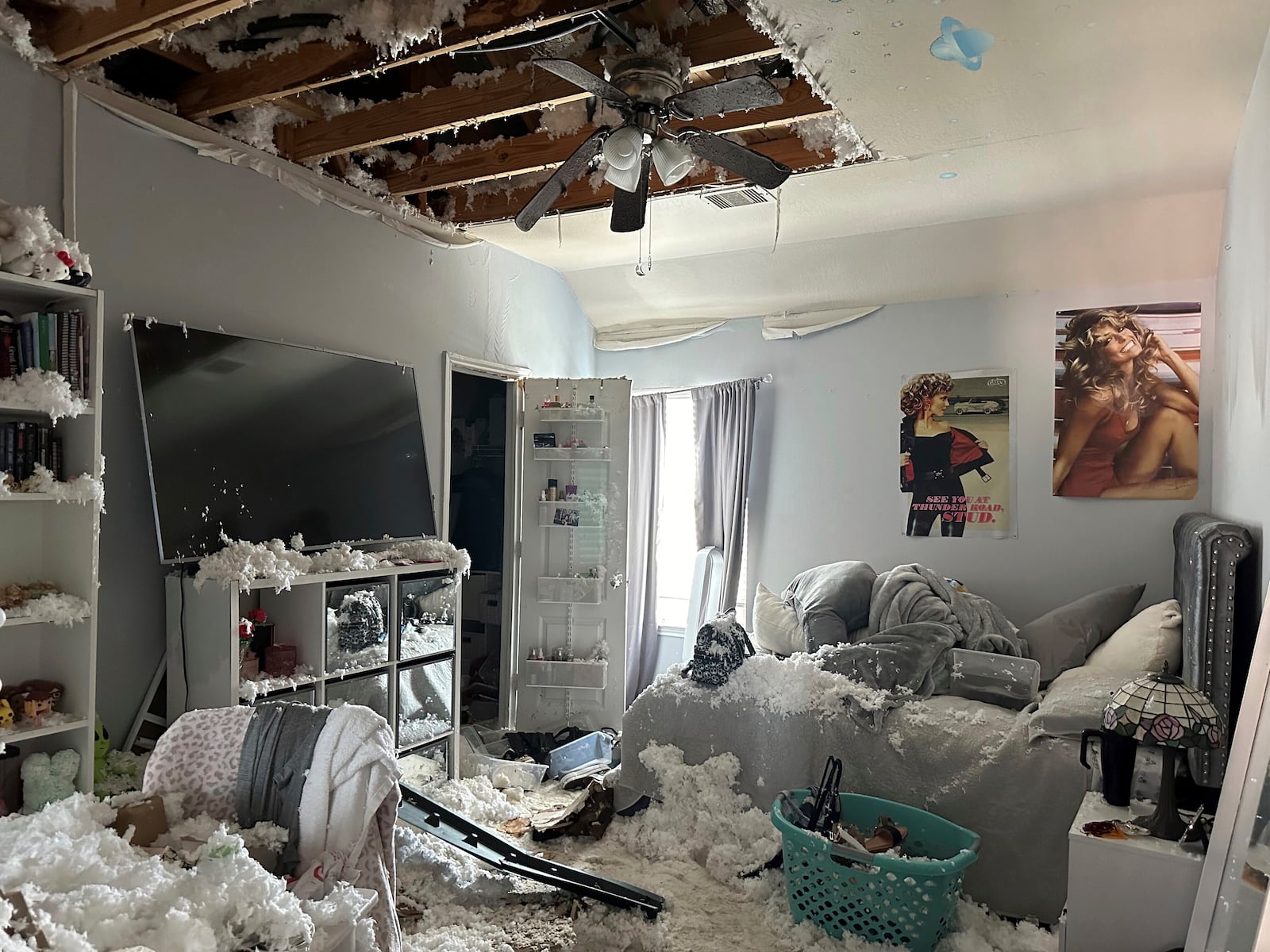 A room in the home of Diane Hutto in Deer Park, Texas, is filled with damp insulation on Thursday, Sept. 19, 2024, after the ceiling was damaged by water that had been used by firefighters to keep at bay the flames and heat from a nearby pipeline fire earlier this week. (AP Photo/Juan A. Lozano)