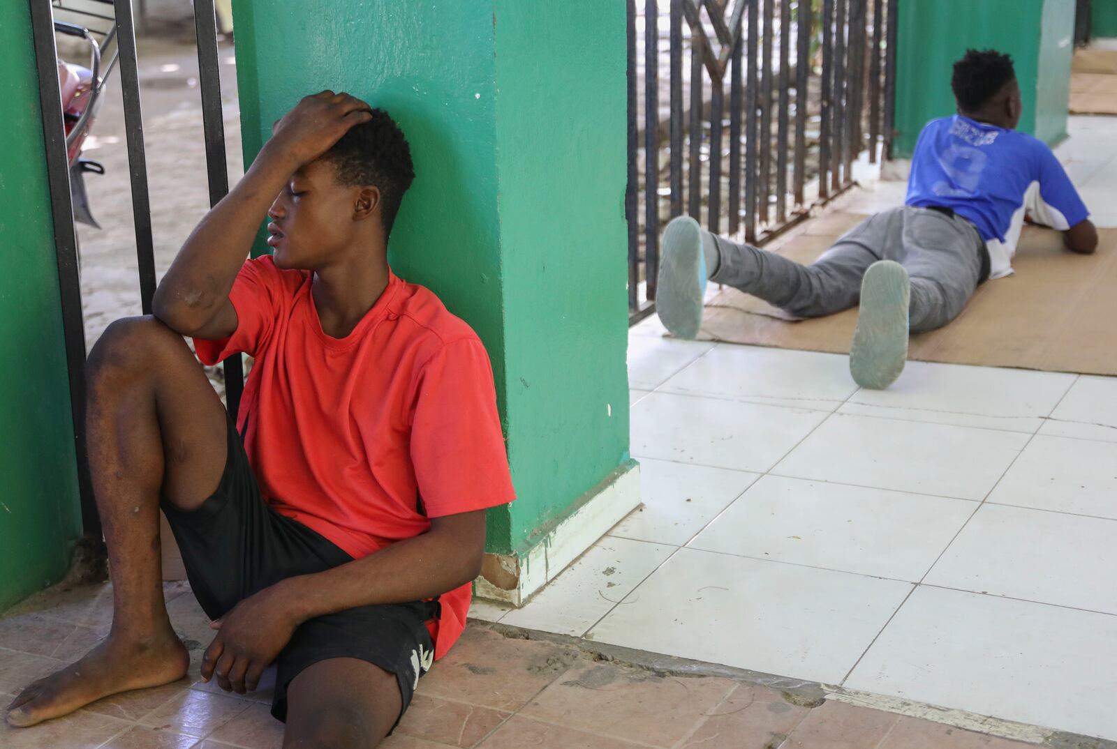 Relatives of people injured during armed gang attacks wait around at Saint Nicolas hospital in Saint-Marc, Haiti, Sunday, Oct. 6, 2024. (AP Photo/Odelyn Joseph)