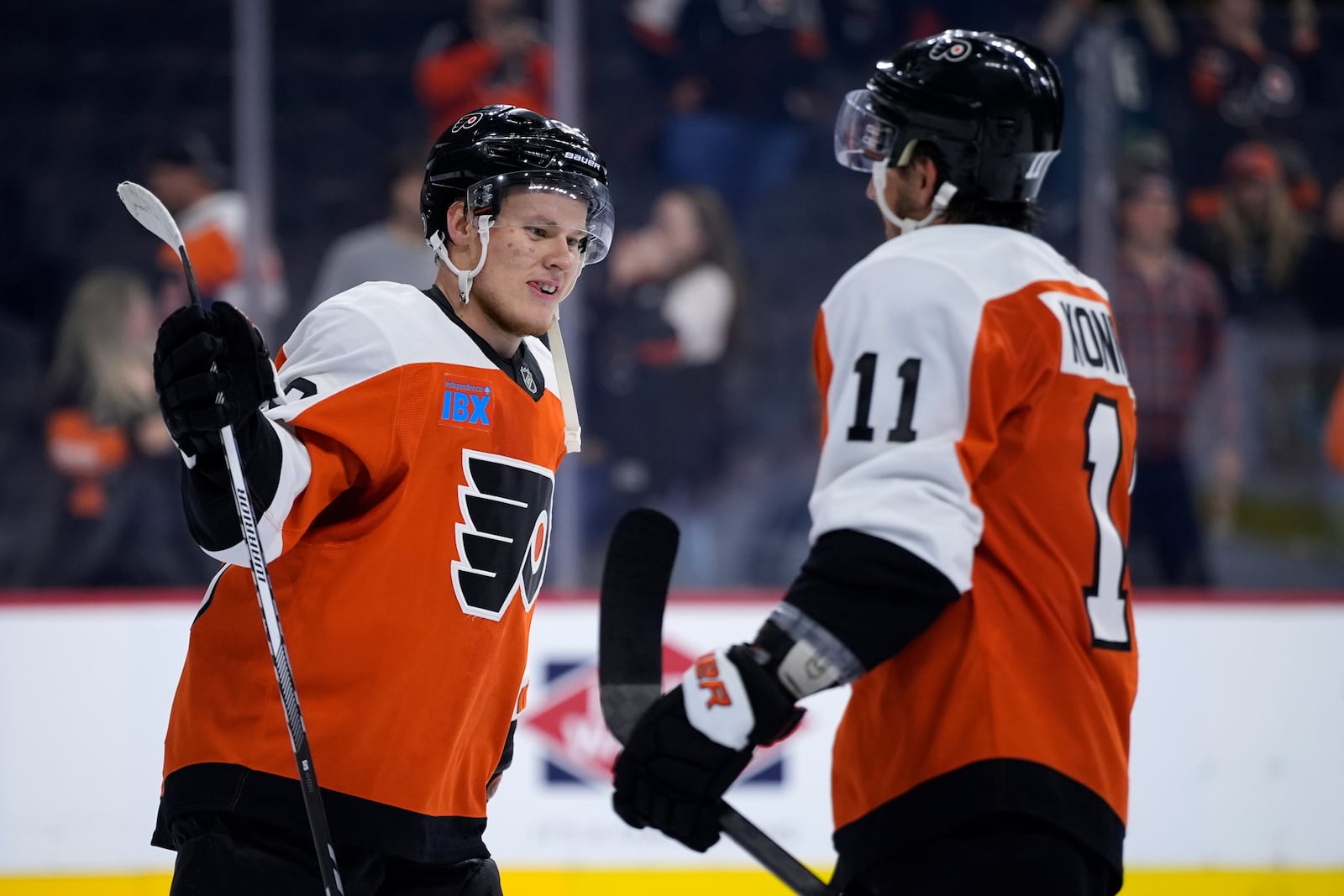 Philadelphia Flyers' Matvei Michkov, left, and Travis Konecny celebrate after a preseason NHL hockey game against the New York Islanders, Thursday, Sept. 26, 2024, in Philadelphia. (AP Photo/Matt Slocum)