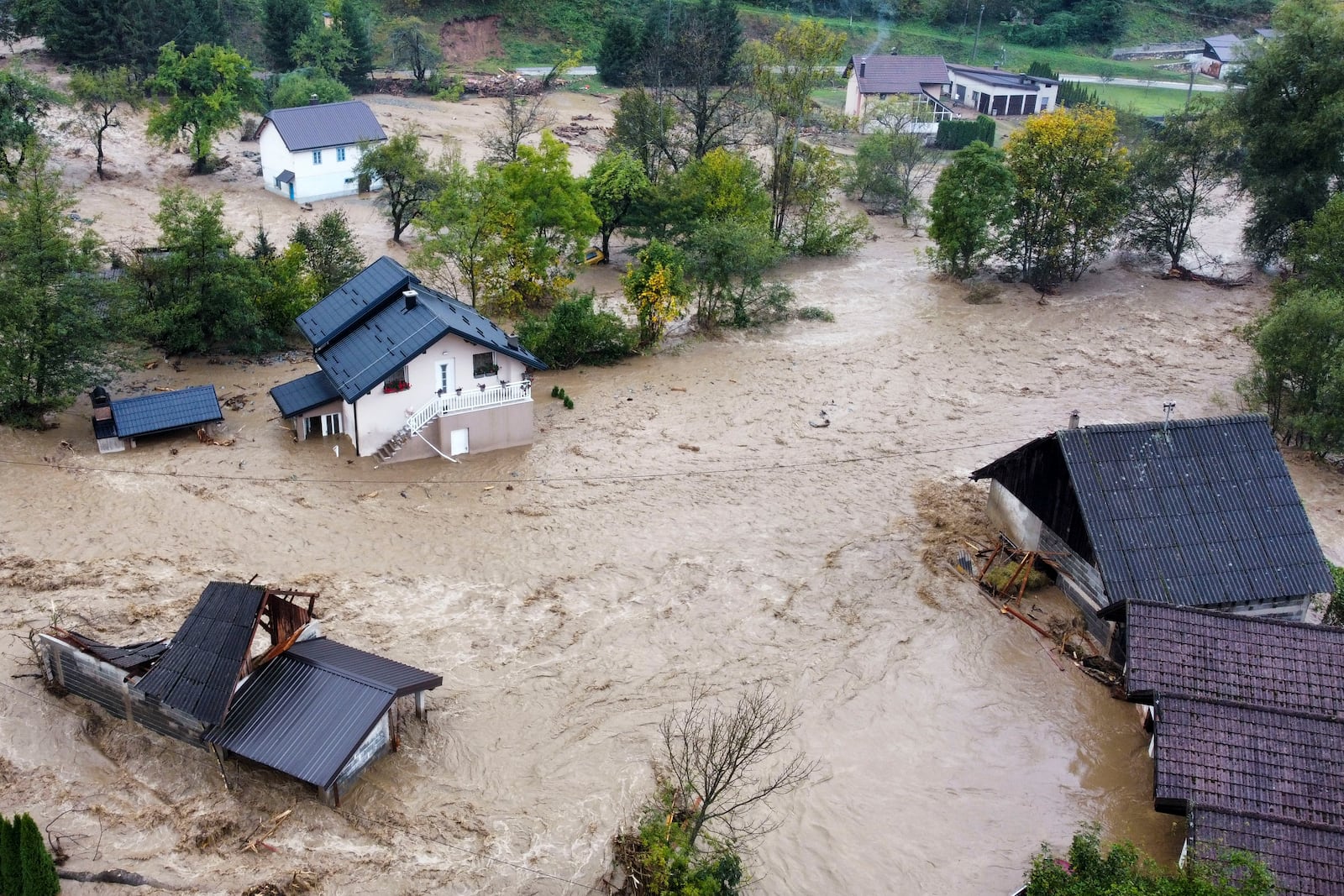 Flooded houses after a heavy rain in the village of Luke, near Bosnian town of Fojnica, 50 kms west of Sarajevo, Bosnia, Friday, Oct. 4, 2024. (AP Photo/Robert Oroz)