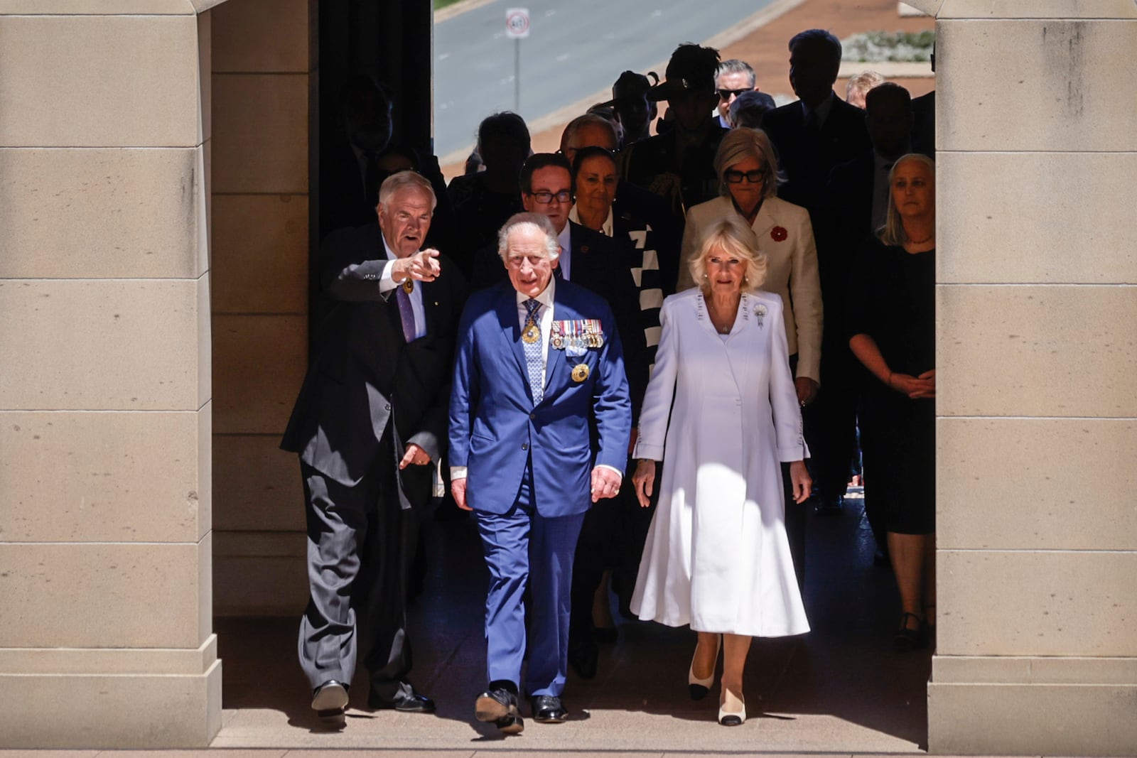 King Charles III and Queen Camilla arrive at the Australian War Memorial accompanied by Australian War Memorial Council Chair Kim Beazley Canberra, left, in Canberra , Australia, Monday, Oct. 21, 2024. (Brook Mitchell/ Pool Photo via AP)