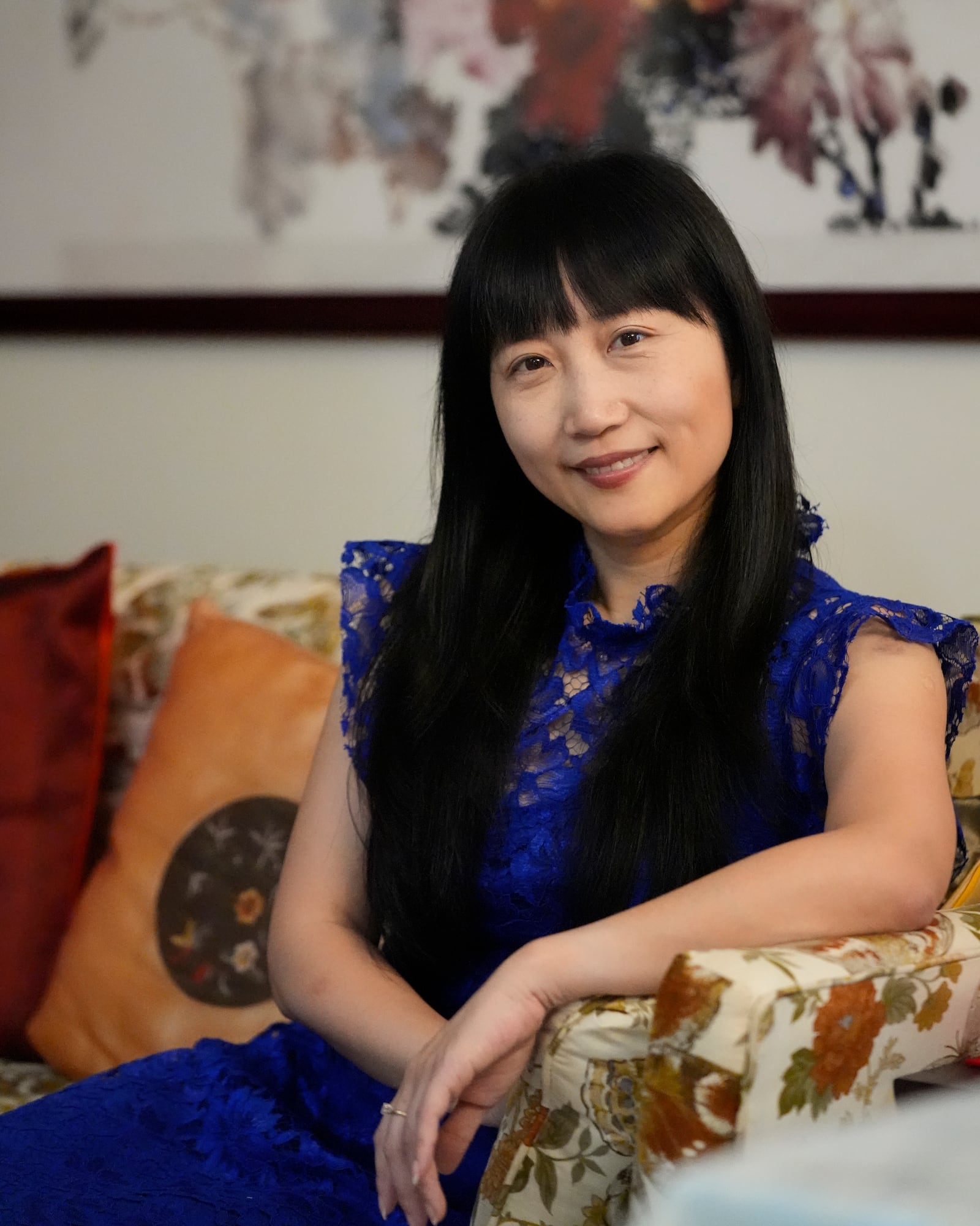 Diana Xue poses for a photo at her home Monday, Oct. 21, 2024, in Orlando, Fla. Xue is a naturalized U.S. citizen born in China who used to vote more Republican but has changed her mind after Florida passed the alien land law. (AP Photo/John Raoux)