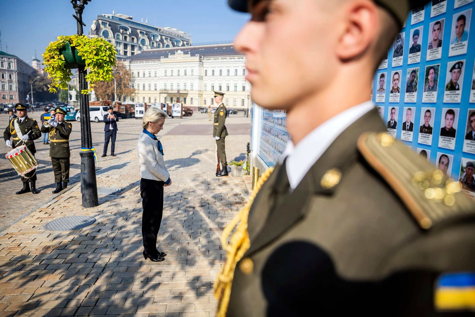 President of the European Commission Ursula von der Leyen, center, visits a wall commemorating the fallen Ukrainian soldiers in the war with Russia, in Kyiv, Ukraine, Friday, Sept. 20, 2024. (Christoph Soeder, Pool via AP)