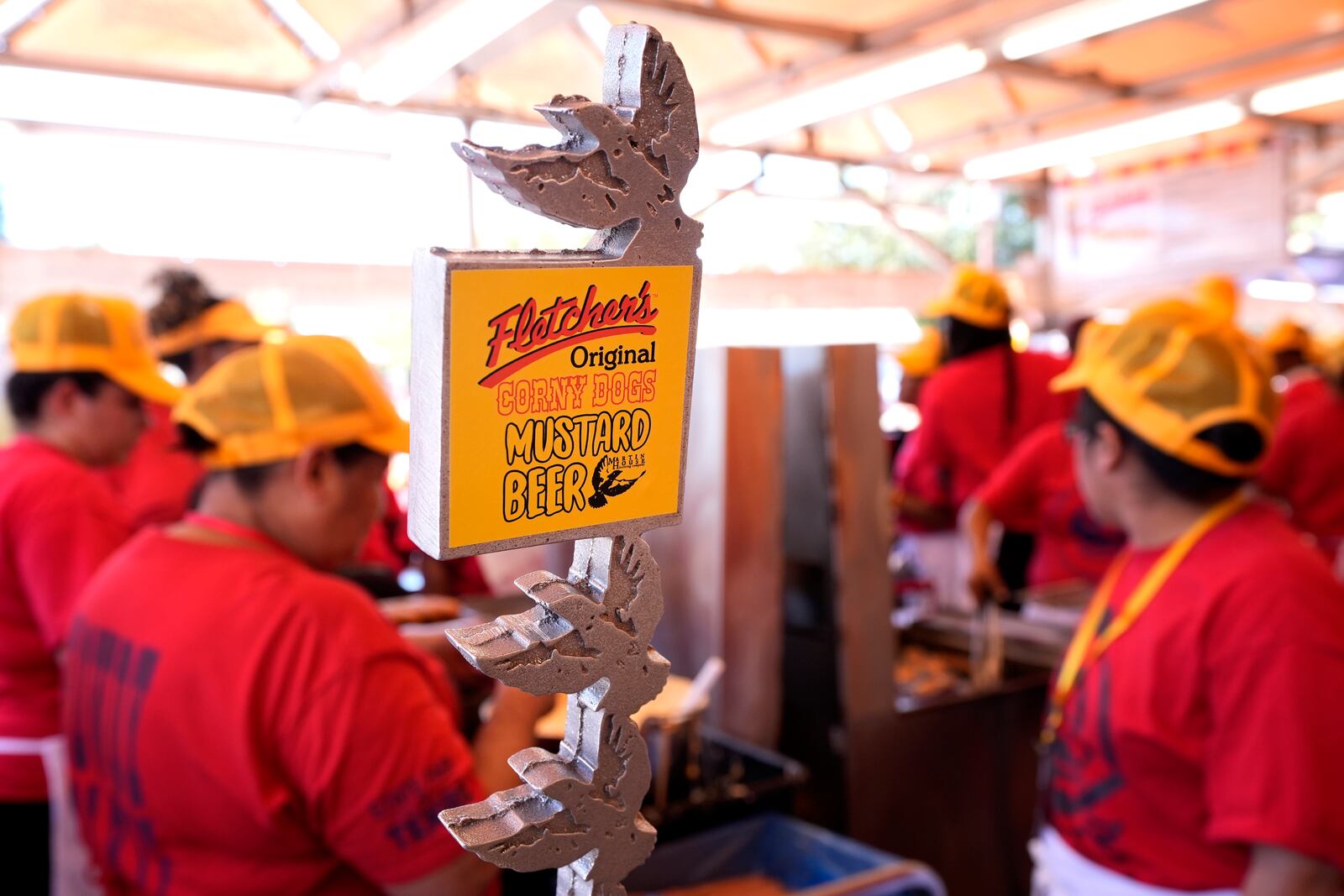 A Fletchers Original Corny Dogs Mustard Beer tap is shown as dozens of workers prepare to the treats at a food booth at the State Fair of Texas in Dallas, Friday, Sept. 27, 2024. (AP Photo/Tony Gutierrez)