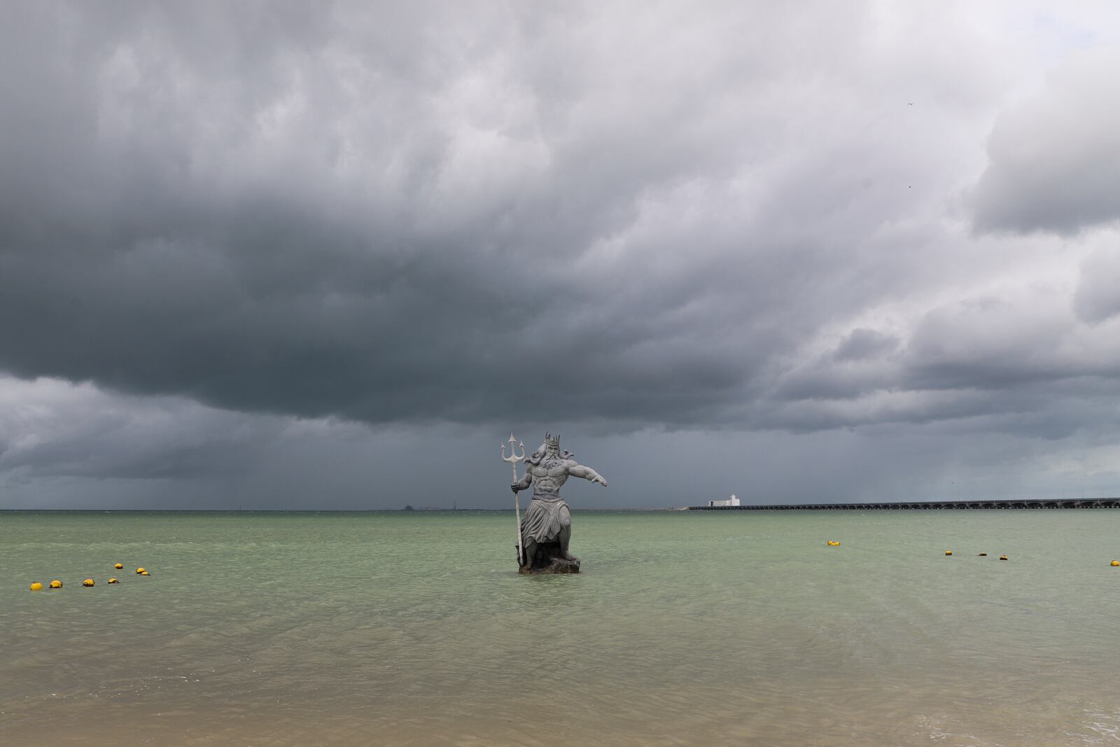 A sculpture of Poseidon stands in the ocean before the arrival of Hurricane Milton, in Progreso, Yucatan state, Mexico, Monday, Oct. 7, 2024. (AP Photo/Martin Zetina)