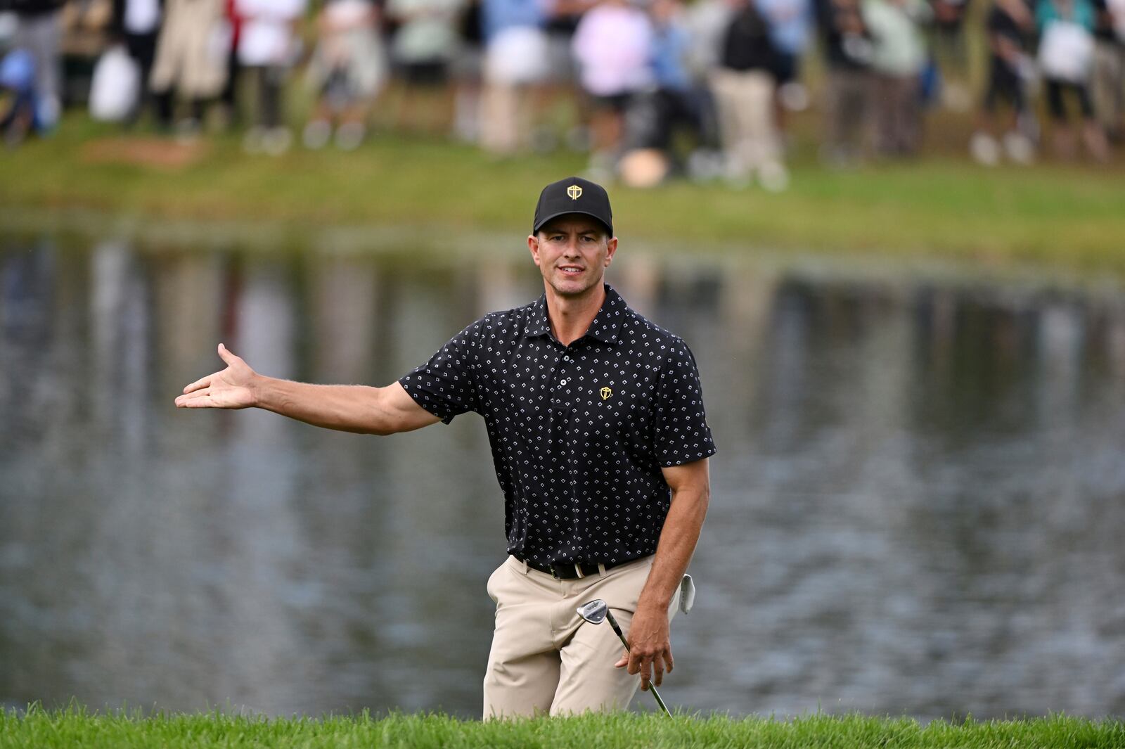 International team member Adam Scott, of Australia, reacts to his shot out of the bunker on the 16th hole during a first round four-ball match at the Presidents Cup golf tournament at the Royal Montreal Golf Club in Montreal, Thursday, Sept. 26, 2024. (Graham Hughes/The Canadian Press via AP)