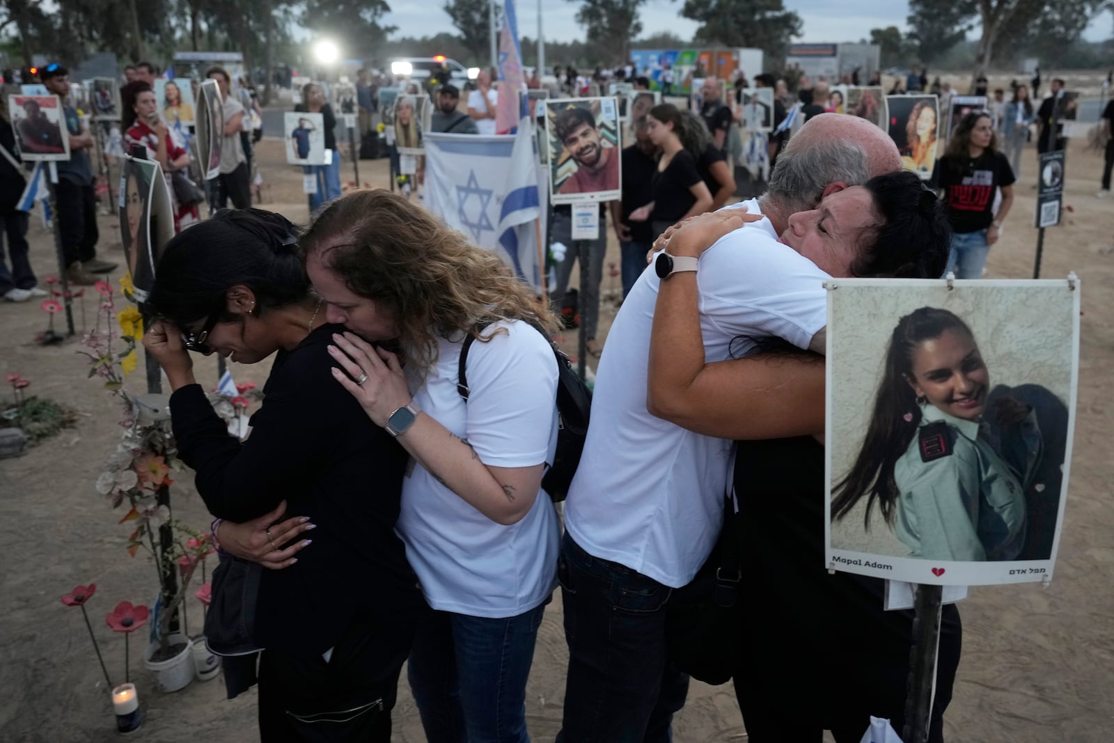 People visit the site of the Nova music festival, where hundreds of revelers were killed and abducted by Hamas and taken into Gaza, on the one-year anniversary of the attack, near Kibbutz Reim, southern Israel, Monday, Oct. 7, 2024. (AP Photo/Ariel Shalit)