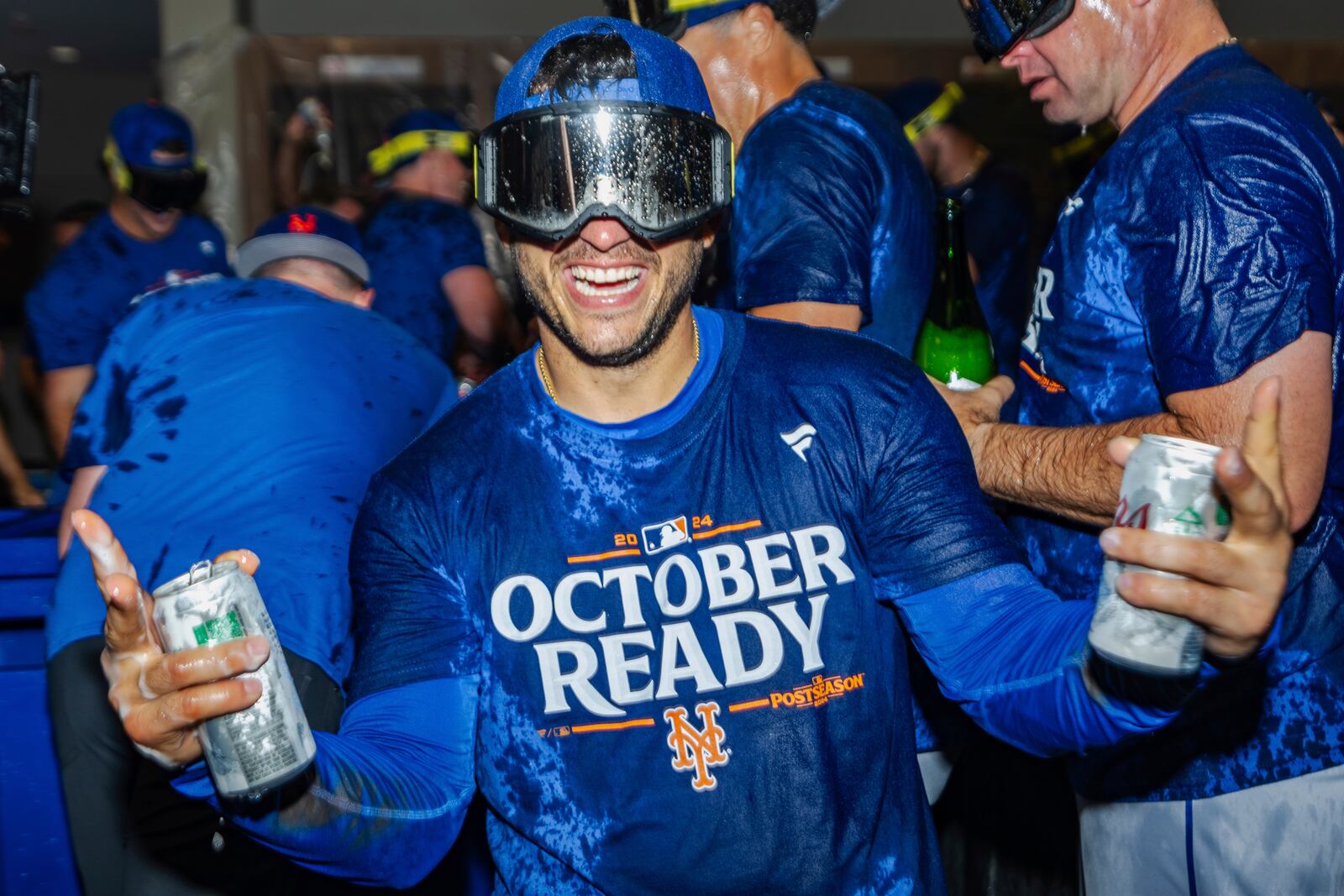 The New York Mets celebrate in the locker room after clinching a playoff berth with a victory in the first baseball game of a doubleheader against the Atlanta Braves, Monday, Sept. 30, 2024, in Atlanta. (AP Photo/Jason Allen)