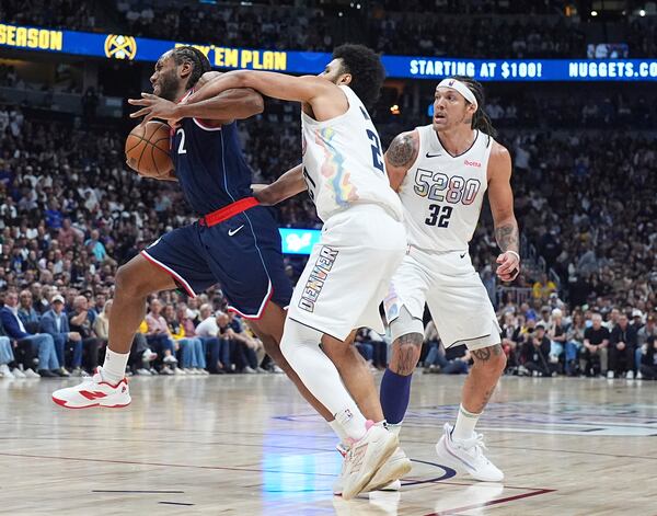 Los Angeles Clippers forward Kawhi Leonard, left, is fouled by Denver Nuggets guard Jamal Murray as forward Aaron Gordon (32) looks on in the second half of Game 5 of an NBA basketball playoff series Tuesday, April 29, 2025, in Denver. (AP Photo/David Zalubowski)