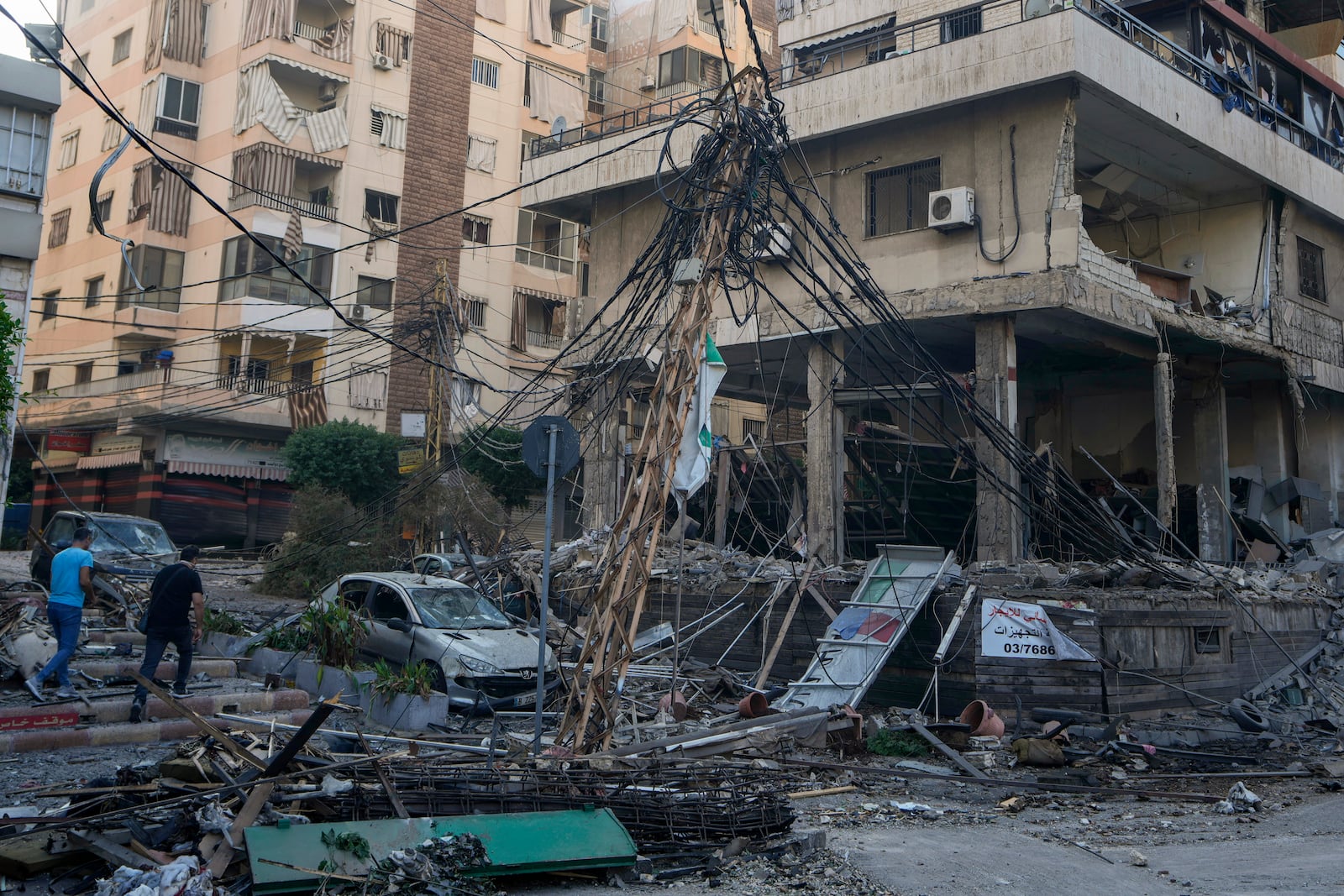 People check the site of an Israeli airstrike in Dahiyeh, Beirut, Lebanon, Sunday, Oct. 6, 2024. (AP Photo/Bilal Hussein)