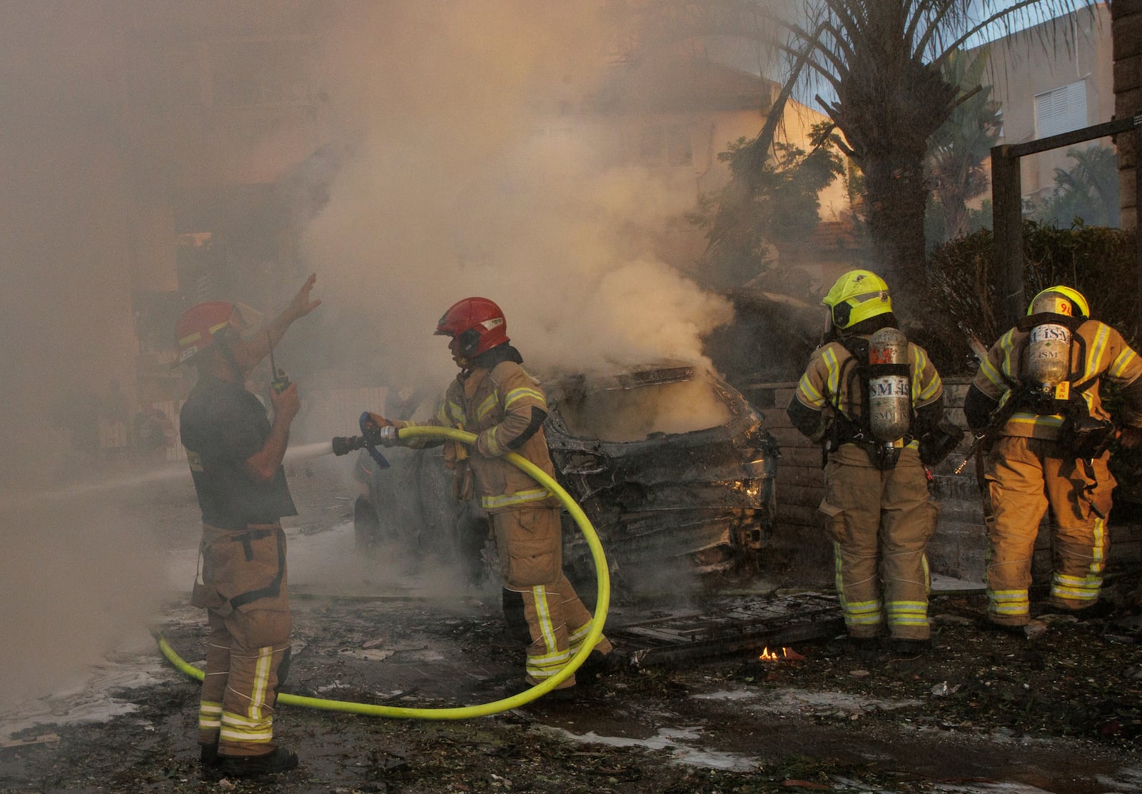 Israeli security and rescue forces work at the site hit by a rocket fired from Lebanon, in Kiryat Bialik, northern Israel, on Sunday, Sept. 22, 2024. (AP Photo/Gil Nechushtan)