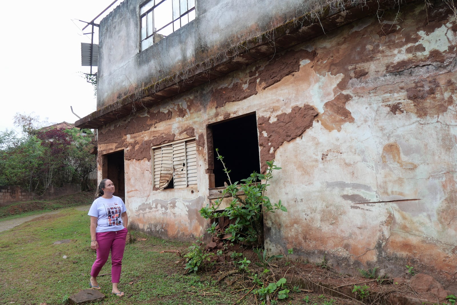 Monica dos Santos, 39, walks past her former village's bar that was destroyed when a dam broke in Bento Rodrigues, Minas Gerais state, Brazil, Oct. 19, 2024. Victims of Brazil’s worst environmental disaster, on Nov. 5, 2015, took their case for compensation to a UK court on Monday, Oct. 21, 2024, almost nine years after tons of toxic mining waste poured into a major waterway, killing 19 people and devastating local communities. (AP Photo/Eleonore Hughes)