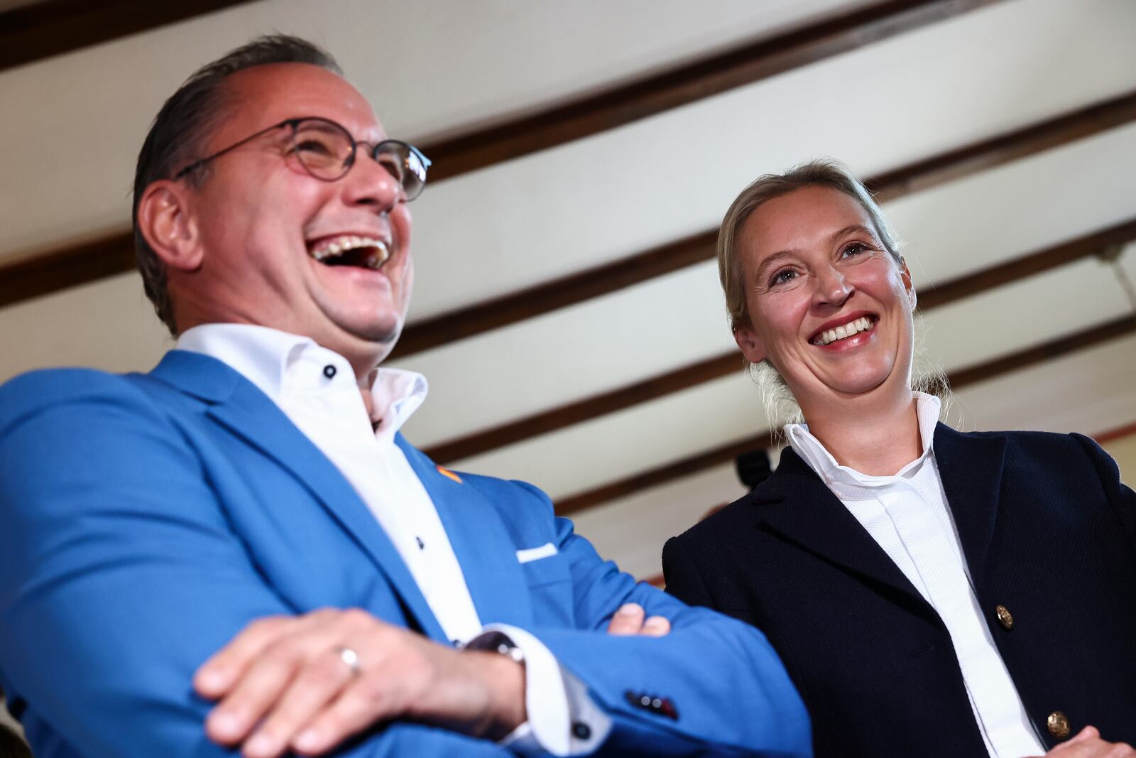 Right-wing Alternative for Germany (AfD) party co-leaders Alice Weidel and Tino Chrupalla react before first exit polls of the Brandenburg state election in Potsdam, Germany, Sept. 22, 2024. (Liesa Johannssen/Pool Photo via AP)