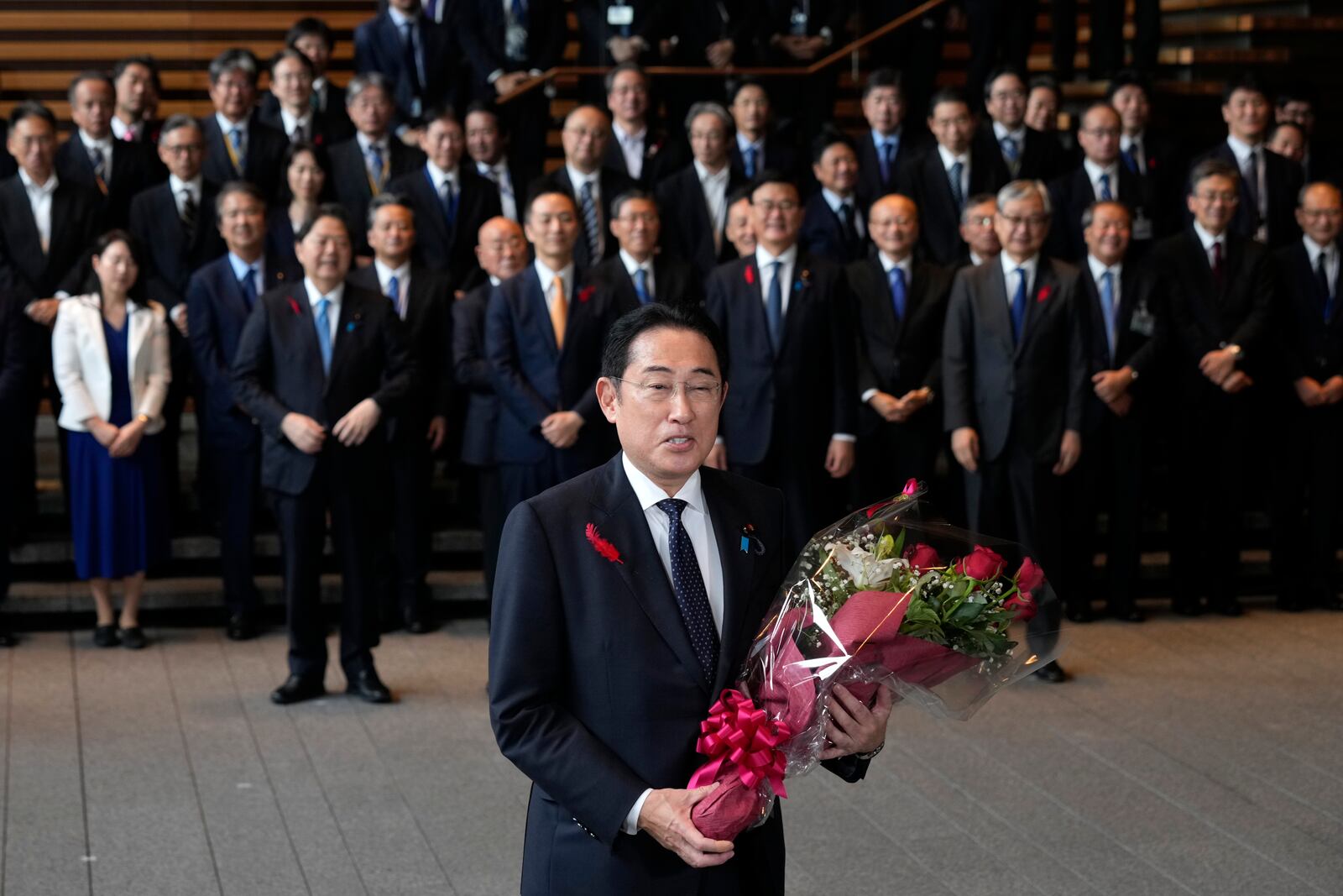 Japan's outgoing Prime Minister Fumio Kishida, center, speaks as he leaves the prime minister's office in Tokyo Tuesday, Oct. 1, 2024. (AP Photo/Hiro Komae)