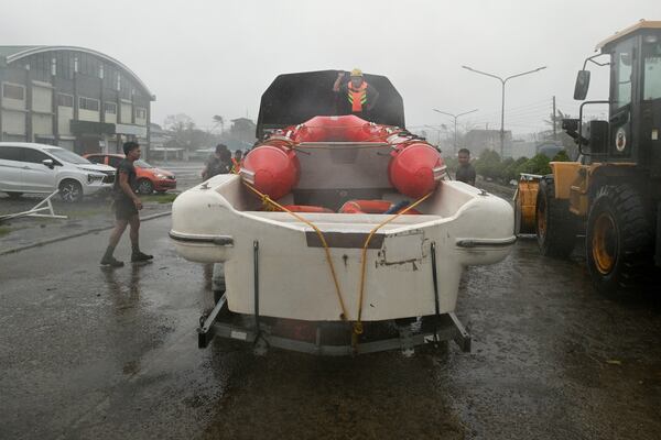 Rescuers prepare a boat during rains caused by Typhoon Usagi at Santa Ana, Cagayan province, northern Philippines on Thursday, Nov. 14, 2024. (AP Photo/Noel Celis)