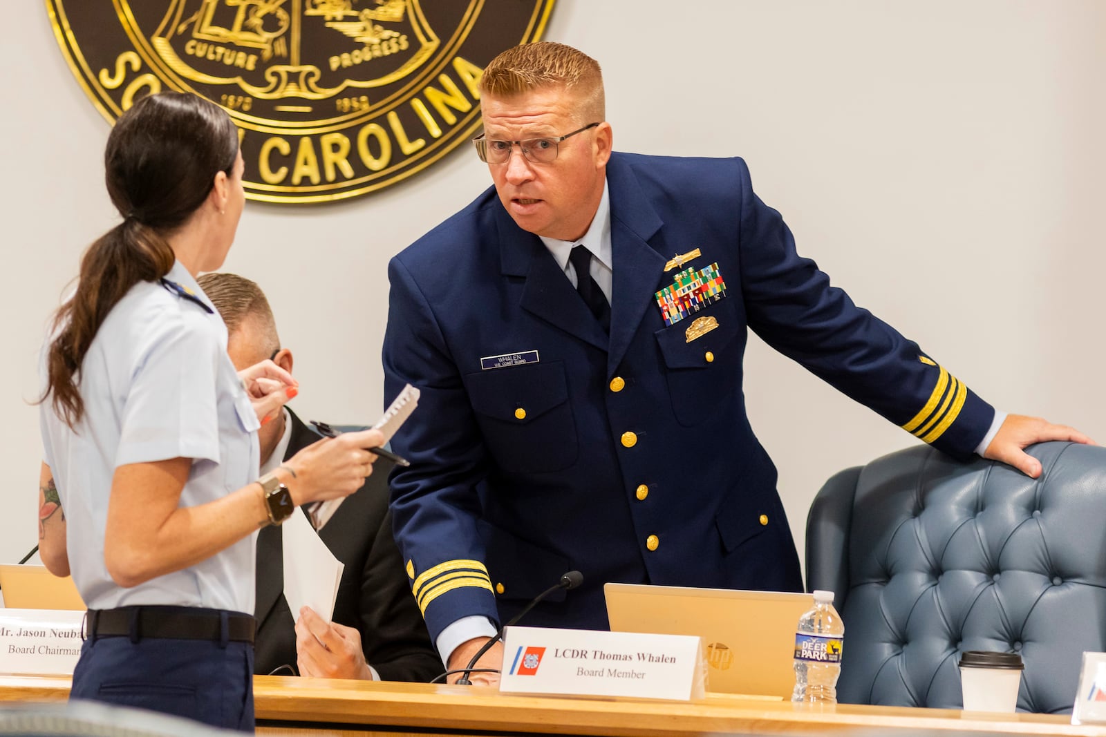 Coast Guard's Thomas Whalen speaks with another Coast Guard member during a break for the Titan marine board formal hearing inside the Charleston County Council Chambers, Monday, Sept. 16, 2024, in North Charleston, S.C. (AP Photo/Mic Smith)