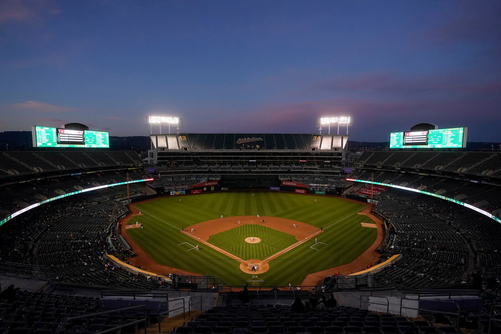 FILE - Fans at Oakland Coliseum watch a baseball game between the Oakland Athletics and the Cincinnati Reds in Oakland, Calif., on April 28, 2023. (AP Photo/Jeff Chiu, File)