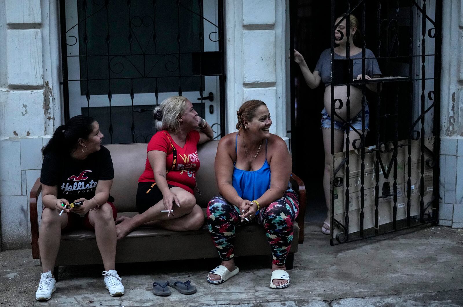 Residents pass the time during a massive blackout after a major power plant failed in Havana, Cuba, Friday, Oct. 18, 2024. (AP Photo/Ramon Espinosa)