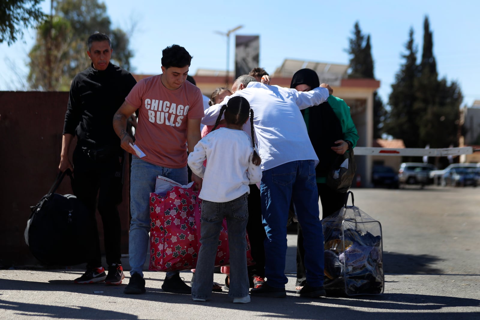 A Syrian family fleeing the war in Lebanon arrive at the Syrian-Lebanese border crossing in Jousieh, Syria, Tuesday, Oct. 2, 2024. (AP Photo/Omar Sanadiki)